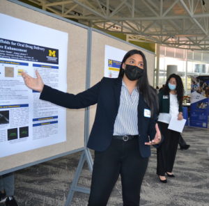 Malini Mukherji stands before her research poster while presenting at the ChE Undergraduate Symposium.