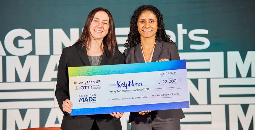 Jessica Beck (left) and Samantha Jayasundera accept their honorary check after the EnergyTech University Prize competition.